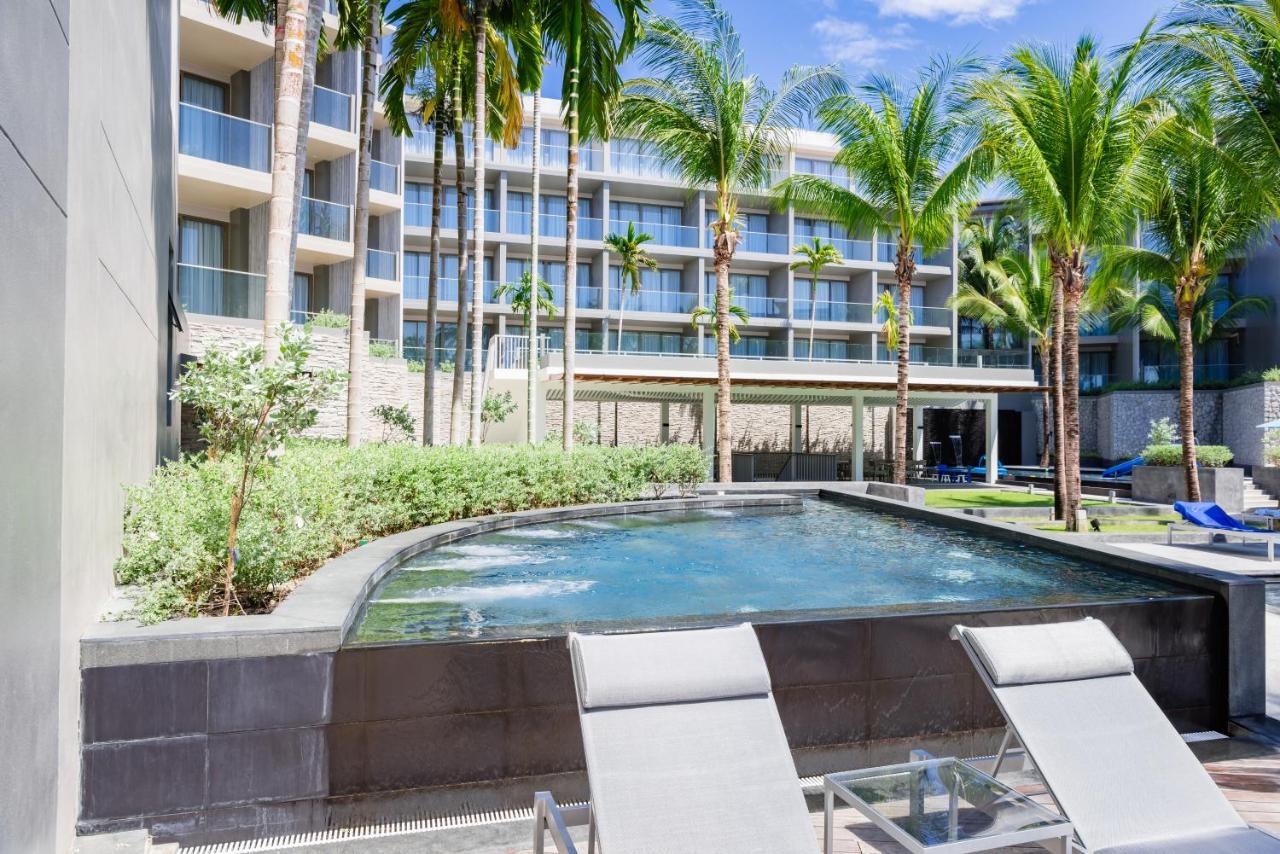 Oceanfront Beach Resort - Sha Extra Plus Patong Exteriör bild The pool at the Hilton